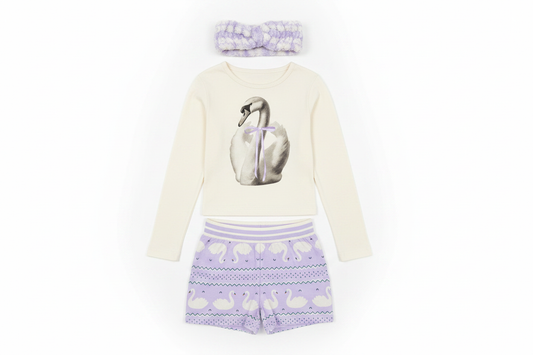 Art Class girls pajama set front-facing flat lay with swan top, lavender shorts, and spa headband